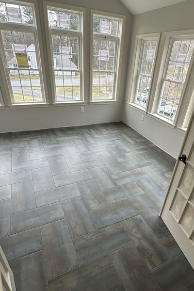 wood look tile floor installation in a Franklin sun room